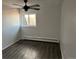 Clean bedroom with wood-look floors, a ceiling fan, and a window with a view at 1285 N Colorado Blvd # 4, Denver, CO 80206
