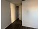 Bedroom with wood-look flooring and open closet with storage space at 1285 N Colorado Blvd # 4, Denver, CO 80206