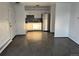 Open kitchen with stainless steel refrigerator, shaker cabinets, and tiled backsplash at 1285 N Colorado Blvd # 4, Denver, CO 80206