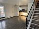 Open living space with vinyl flooring, white walls, and a staircase leading to the upper level at 1285 N Colorado Blvd # 4, Denver, CO 80206