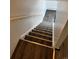 A set of stairs featuring updated wood-look treads, white risers, and a handrail at 1285 N Colorado Blvd # 4, Denver, CO 80206