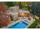 Stunning aerial view of the home with a swimming pool, outdoor dining, lush landscaping, and mature trees at 9 Polo Field Ln, Denver, CO 80209