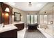 Luxurious bathroom featuring a soaking tub, glass shower, and custom cabinetry at 9 Polo Field Ln, Denver, CO 80209
