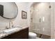 Modern bathroom featuring a glass-enclosed shower, designer sink, and decorative fixtures at 9 Polo Field Ln, Denver, CO 80209