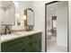 Bathroom featuring double vanity, framed mirrors, and decorative sconces and lighting at 9 Polo Field Ln, Denver, CO 80209