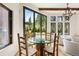 Cozy breakfast nook with glass table and outdoor views of the patio and backyard at 9 Polo Field Ln, Denver, CO 80209