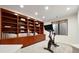 Basement exercise room with large built-in shelving at 9 Polo Field Ln, Denver, CO 80209