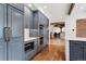 Modern kitchen with light blue cabinets, stainless steel appliances, and hardwood flooring at 9 Polo Field Ln, Denver, CO 80209