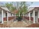 Charming courtyard featuring a table and seating between buildings with brick and white pillars at 4072 Ames St, Wheat Ridge, CO 80212