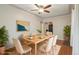 Bright dining room featuring a light wood table and six chairs at 4072 Ames St, Wheat Ridge, CO 80212