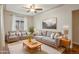 Comfortable living room with gray sofas, ceiling fan and natural light at 4072 Ames St, Wheat Ridge, CO 80212
