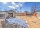 The large backyard features a detached garage and additional storage sheds at 3164 Scranton St, Aurora, CO 80011