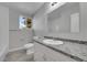 Updated bathroom featuring new fixtures, vanity, flooring, and shower/tub at 3164 Scranton St, Aurora, CO 80011