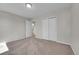 Bedroom featuring neutral colored carpeting, and a hallway leading to a bathroom at 3164 Scranton St, Aurora, CO 80011