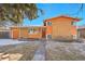 Charming orange brick home featuring a red front door and well-maintained yard at 3164 Scranton St, Aurora, CO 80011