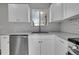 Updated kitchen with granite countertops, subway tile backsplash, stainless steel appliances and white cabinets at 3164 Scranton St, Aurora, CO 80011