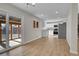 Open concept living room with luxury vinyl flooring connecting to an updated kitchen at 3164 Scranton St, Aurora, CO 80011
