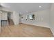 Bright living room with hardwood floors, large window, and staircase at 3164 Scranton St, Aurora, CO 80011