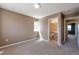 Cozy bedroom with neutral walls, soft carpeting, and an adjacent bathroom at 8751 Pearl St # D1, Thornton, CO 80229