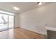 Bright bedroom with sliding glass door to balcony and hardwood floors at 8751 Pearl St # D1, Thornton, CO 80229