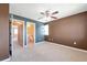 Spacious carpeted main bedroom with ceiling fan and ensuite bathroom access at 8751 Pearl St # D1, Thornton, CO 80229