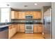 Updated kitchen with stainless steel appliances, sleek countertops, and light wood cabinets at 8751 Pearl St # D1, Thornton, CO 80229