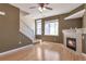 Comfortable living room with fireplace, staircase, and natural lighting at 8751 Pearl St # D1, Thornton, CO 80229