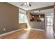 Open concept living area with windows, adjacent kitchen, and balcony access at 8751 Pearl St # D1, Thornton, CO 80229
