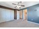 Spacious main bedroom featuring a ceiling fan and ample closet space, with neutral carpeting at 8751 Pearl St # D1, Thornton, CO 80229