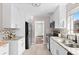 Modern kitchen with white cabinets, stainless steel appliances, and granite countertops at 357 Zenobia St, Denver, CO 80219