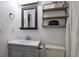 Clean bathroom featuring a gray vanity, toilet, and shelving for a modern aesthetic at 1567 S Sedalia St, Aurora, CO 80017