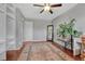 Inviting bedroom with ceiling fan, decorative rug, open closet shelves and hardwood floors at 1567 S Sedalia St, Aurora, CO 80017