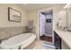 Bathroom with a soaking tub, a shower, and a marble-topped vanity at 7220 W Bonfils Ln # 206, Lakewood, CO 80226