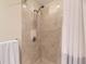 A tiled shower features sleek fixtures and a refreshing design at 7220 W Bonfils Ln # 206, Lakewood, CO 80226