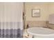Bathroom featuring a soaking tub with shower curtain at 7220 W Bonfils Ln # 206, Lakewood, CO 80226