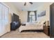 Well-lit bedroom with fan and bed. Big window and large closet, providing comfort and style at 7220 W Bonfils Ln # 206, Lakewood, CO 80226
