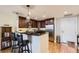 Open kitchen design with stainless steel appliances, a breakfast bar, and hardwood floors at 7220 W Bonfils Ln # 206, Lakewood, CO 80226