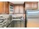 Elegant kitchen featuring stainless steel refrigerator, granite countertops and wood cabinets at 7220 W Bonfils Ln # 206, Lakewood, CO 80226