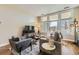 Bright living room featuring hardwood floors, large windows, and comfortable modern furnishings at 7220 W Bonfils Ln # 206, Lakewood, CO 80226