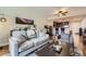 Open-concept living room leading into the kitchen with comfortable seating and a large entertainment center at 7220 W Bonfils Ln # 206, Lakewood, CO 80226
