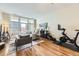 Inviting living room featuring a cozy seating area, a Peloton bike, and a bright balcony at 7220 W Bonfils Ln # 206, Lakewood, CO 80226