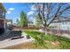 Expansive backyard featuring lush lawn, mature tree, and patio area ideal for outdoor relaxation and entertaining at 13884 Lilac St, Thornton, CO 80602