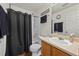 Well lit bathroom with a shower over bath, toilet, and single sink vanity at 13884 Lilac St, Thornton, CO 80602