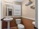 Cozy Half-Bath featuring a toilet and sink at 13884 Lilac St, Thornton, CO 80602