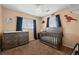 Sweet Bedroom with dark wood crib, changing table, and cute decor at 13884 Lilac St, Thornton, CO 80602