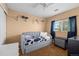 Cozy bedroom features neutral walls, a large window, and a soft daybed at 13884 Lilac St, Thornton, CO 80602