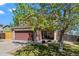 Charming two-story home featuring a two-car garage and manicured lawn in a suburban neighborhood at 13884 Lilac St, Thornton, CO 80602