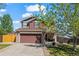 Charming two-story home featuring a two-car garage and manicured lawn in a suburban neighborhood at 13884 Lilac St, Thornton, CO 80602