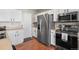 Modern kitchen featuring white cabinets, stainless steel appliances and a refrigerator at 13884 Lilac St, Thornton, CO 80602