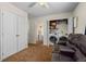 Bright laundry room includes a washer and dryer, closet space, and seating area at 13884 Lilac St, Thornton, CO 80602